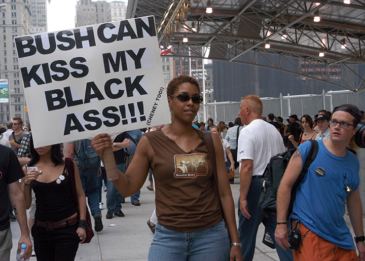 Woman protester at Ground Zero (former site of the World Trade Center) as thousands converged on New York City for demonstrations against the 2004 Republican National Convention (RNC), over the war in Iraq and other issues. 